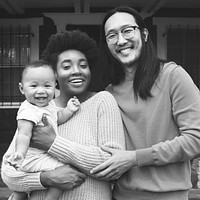 Black and white multicultural family standing in front of their place during covid19 lockdown