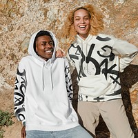 Happy couple in stylish hoodies for winter outdoor shoot
