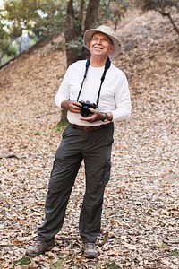 Retired man appreciating the beauty of forest