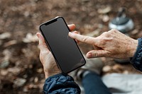 Smartphone black screen mockup psd with senior woman holding it