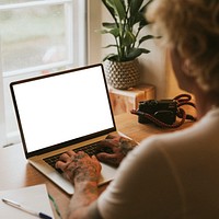 Tattooed man working on tablet screen mockup