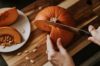 Woman slicing pumpkin for Thanksgiving dinner food photography