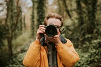 Photographer man taking a photo outdoor traveling