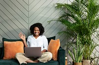 Smiling woman during conference call on laptop working from home in the new normal