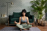 Healthy woman meditating in the living room