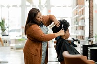 Hairstylist trimming the customer's hair at a beauty salon