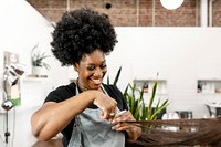 Hairstylist giving a haircut to a customer at a beauty salon 