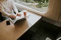 Man working on a laptop on his business trip on a train