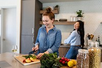 Roommates cooking vegan dinner in the kitchen