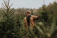 Man shopping for the perfect Christmas tree for Christmas holidays