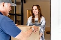 Brunette woman receiving package box from delivery man, online shopping image