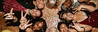 Friends lying on the floor at a party with balloons 