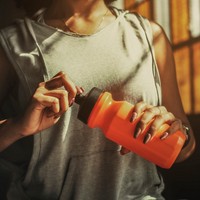 Sporty woman hydrating during a workout 