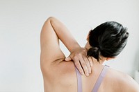 Back view of fitness woman reaching her back