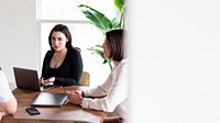 Businesswoman using laptop in a meeting