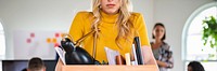 Young businesswoman carrying a wooden box