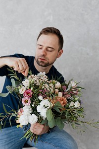 Man rearranging the bouquet of flowers