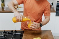 Man pouring orange juice into a glass