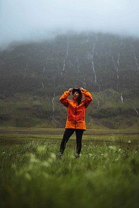 Woman in waterproof jacket while trekking in the highlands