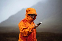 Woman using her mobile phone in the highlands