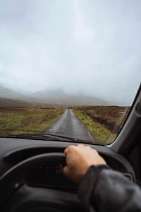 Man driving in a car in the highlands