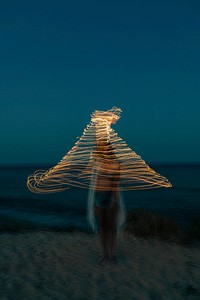 Woman riding on man's shoulder at the beach