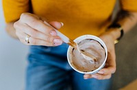 Closeup of woman eating a chocolate ice cream