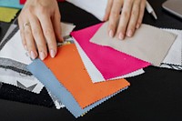 Female fashion designer choosing fabric samples