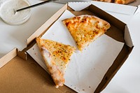 Two slices of cheese pizza in a box
