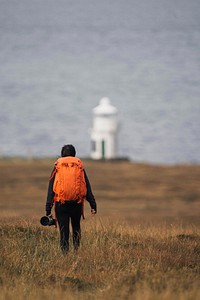 Female photographer at Vaternish Lighthouse on Isle of Skye, Scotland