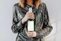 Woman holding a champagne bottle mockup