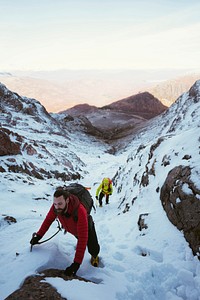 Mountaineers climbing the snowy mountain