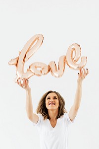 Woman holding a love foil balloon