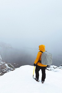 Hiker up in Reinebringen in the Lofoten Islands, Norway