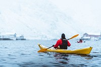 Woman paddling a kayak in Lofoten, Norway