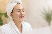 Woman in bathrobe with towel on head