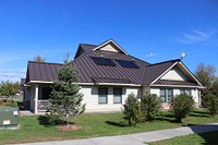 Energy-efficient homes in the Saint Regis Mohawk Tribe Akwesanse Housing Authority&rsquo;s Sunrise Acres Complex include such features as rooftop solar domestic hot water. October 2015. Original public domain image from <a href="https://www.flickr.com/photos/departmentofenergy/22518404146/" target="_blank">Flickr</a>