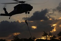 U.S. Marines with Force Reconnaissance Company, 3rd Reconnaissance Battalion, 3rd Marine Division, III Marine Expeditionary Force; British Royal Marines with J Company, 42 Commando and Sailors with Explosive Ordinance Disposal Mobile Unit 5 conduct special insertion and raids training with a section of MH-60Ss from Helicopter Sea Combat 25 on March 19, 2018, on Guam. The units are conducting joint, combined training in order to develop shared standard-of-procedures in a visit, board, search and seizure environment so they can provide a more flexible and mission-ready capability to geographic combatant commanders in the Pacific.