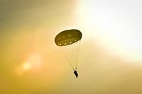 A U.S. Army paratrooper assigned to the 4th Infantry Brigade Combat Team (Airborne), 25th Infantry Division, U.S. Army Alaska, descends to the ground after an airborne training jump from a CH-47 Chinook helicopter on Malemute drop zone at Joint Base Elmendorf-Richardson, Alaska, Thursday, Nov. 3, 2016. The Soldiers of 4/25 IBCT belong to the only American airborne brigade in the Pacific and are trained to execute airborne maneuvers in extreme cold weather/high altitude environments in support of combat, partnership and disaster relief operations. (U.S. Air Force photo/Justin Connaher). Original public domain image from Flickr