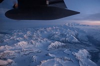Denali, the highest mountain peak in North America, as seen from an Alaska Air National Guard HC-130 Hercules assigned to the 144th Airlift Squadron, while supporting Toys for Tots over Alaska, Nov. 28, 2016. Toys for Tots is supported by the United States Marine Corps Reserve with a goal of delivering, through a new toy, a message of hope to youngsters that will assist them in becoming responsible, productive and patriotic citizens. Two teams of Marines traveled via snow machine to 10 remote villages in the vicinities of Kotzebue to deliver toys to children during the holiday season. (U.S. Air Force photo/Alejandro Pena). Original public domain image from Flickr