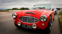 Red Austin Healey model parked outside. Original public domain image from Flickr