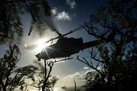 A U.S. Marine UH-1N Huey helicopter assigned to Marine Light Attack Helicopter Squadron (HMLA) 367, flies from Ulupa'u Crater back to Marine Corps Air Station, Kaneohe Bay, after Marine Aircraft Group 24 Corporals Course graduation at the crater's summit, Feb. 9, 2018.