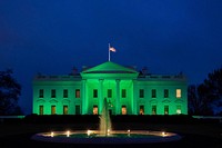 The White House is lit in green light Wednesday, March 17, 2021, in recognition of St. Patrick’s Day. (Official White House Photo by Cameron Smith). Original public domain image from Flickr