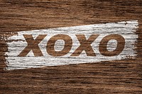 XOXO printed word typography coarse wood texture