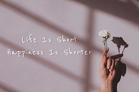 Life is short happiness is shorter quote on a natural light background