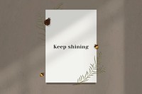 Wall keep shining motivational quote on white paper with flower decoration