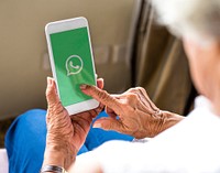 Elderly woman using Whatsapp application on a phone. BANGKOK, THAILAND, 1 NOV 2018.