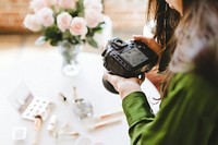 Female photographer shooting beauty products, white tone