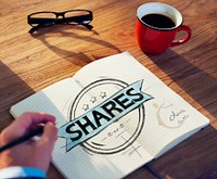 Businessman's table with Shares Concept