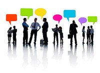 Group Of Business People Discussing And Multi-Colored Speech Bubbles Above Them.